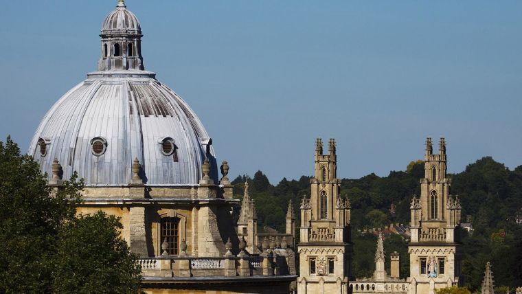 Picture shows the skyline of the Oxford Radcliffe Camera with some trees in the back drop.