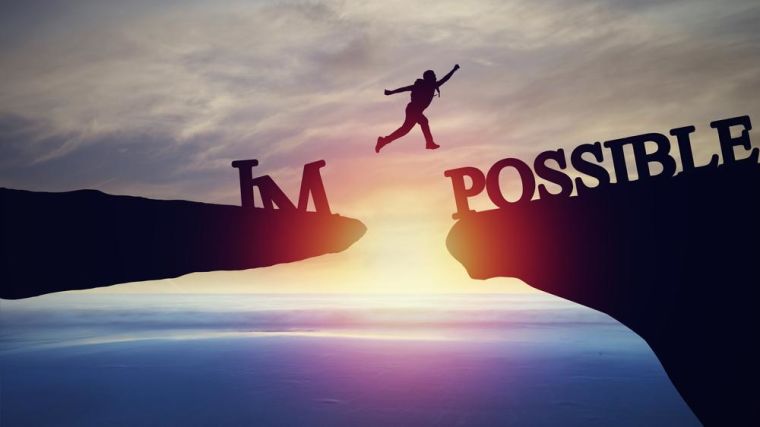 Image shows someone jumping between rocks with the broken word on each side saying 'impossible'.
