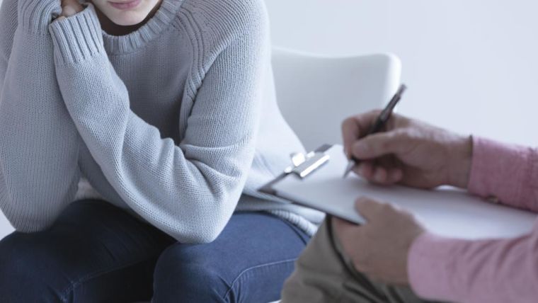 Image of a young person talking to a therapist.