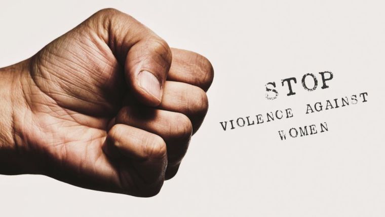 Clench fist with the words 'stop violence against women'.