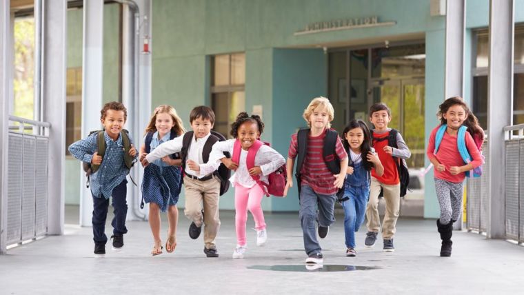 Group of primary school age children running.