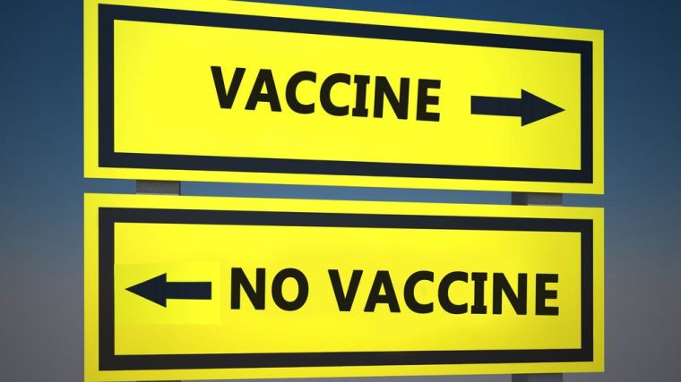 Signs pointing in opposite directions, one with Vaccine and one with No Vaccine written on them