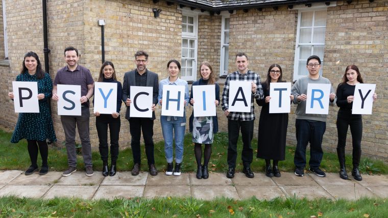 Members of the department holding up the letters spelling out PSYCHIATRY